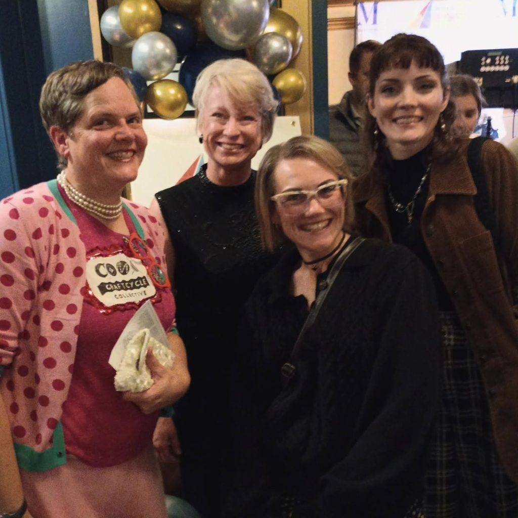 Como Craftcycle celebrated getting nominated for the Columbia Progress Award in 2025. Co-Founder Lisa smiles and poses with board members Darcy, Zoe, & supporter Ashley at the award event.